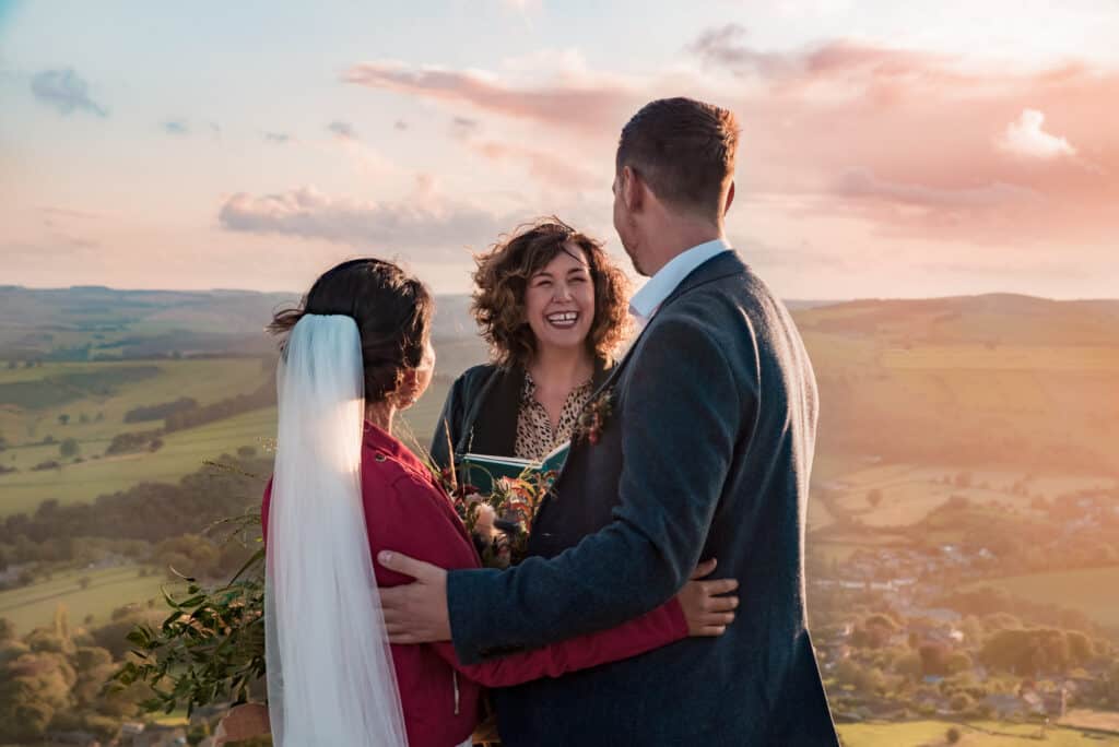 Celebrant in Wales Wedding celebrant marrying couple outside with view of Welsh countryside. Training to be a