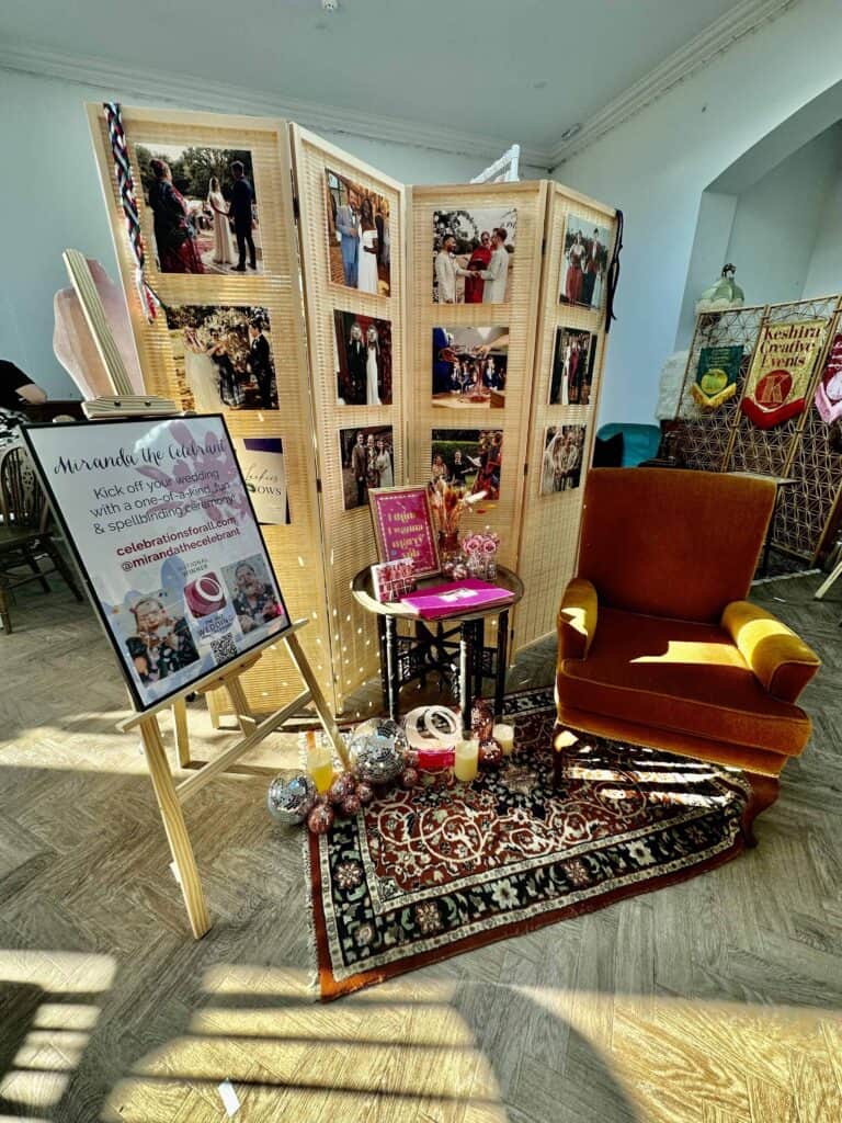 Stand set up with display poster on an easel, chair and decoarted celebrant table