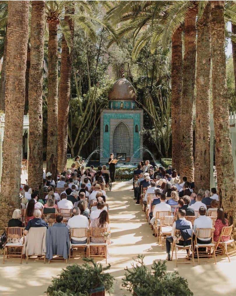 Sophie Li a Bilingual Celebrant in Spain conducting a wedding ceremony under date palm canopy in Elche