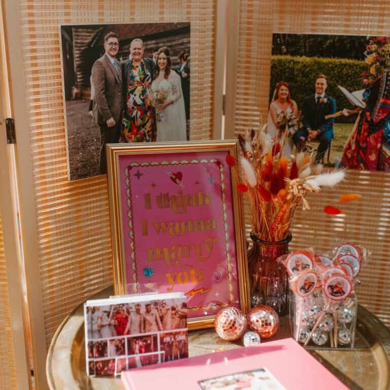 a celebrant guide to attending wedding fairs backdrop with celebrant photos, a celebrant photobook, branded lollipops and mini disco balls